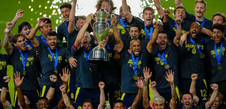 Team celebrating with trophy after championship victory