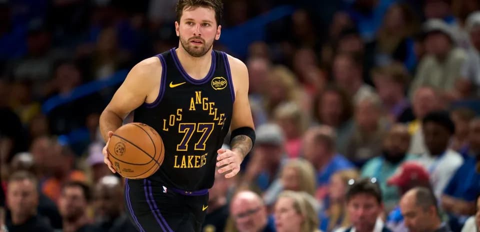 Player dribbling basketball during game in stadium
