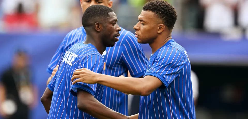 Two players in blue jerseys interacting before match
