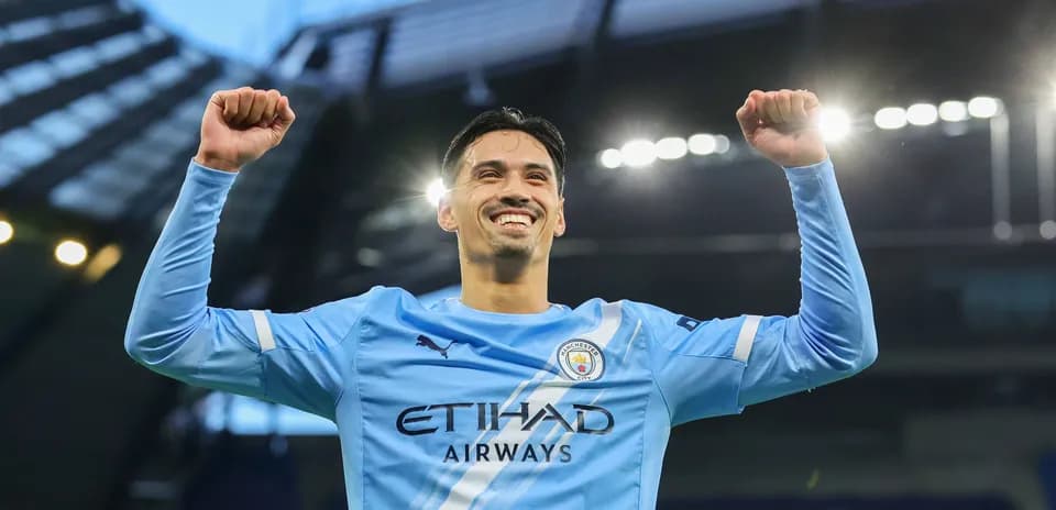 Player celebrating victory at Manchester City stadium