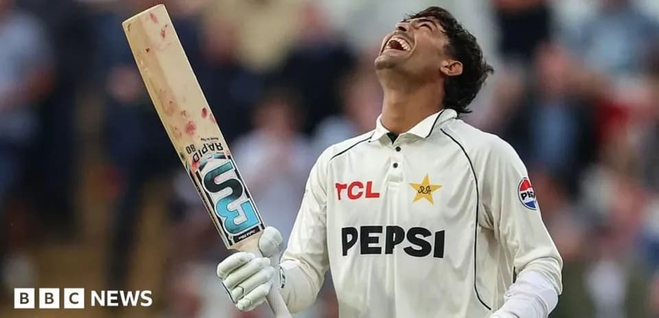 Cricketer celebrating with bat raised in victory