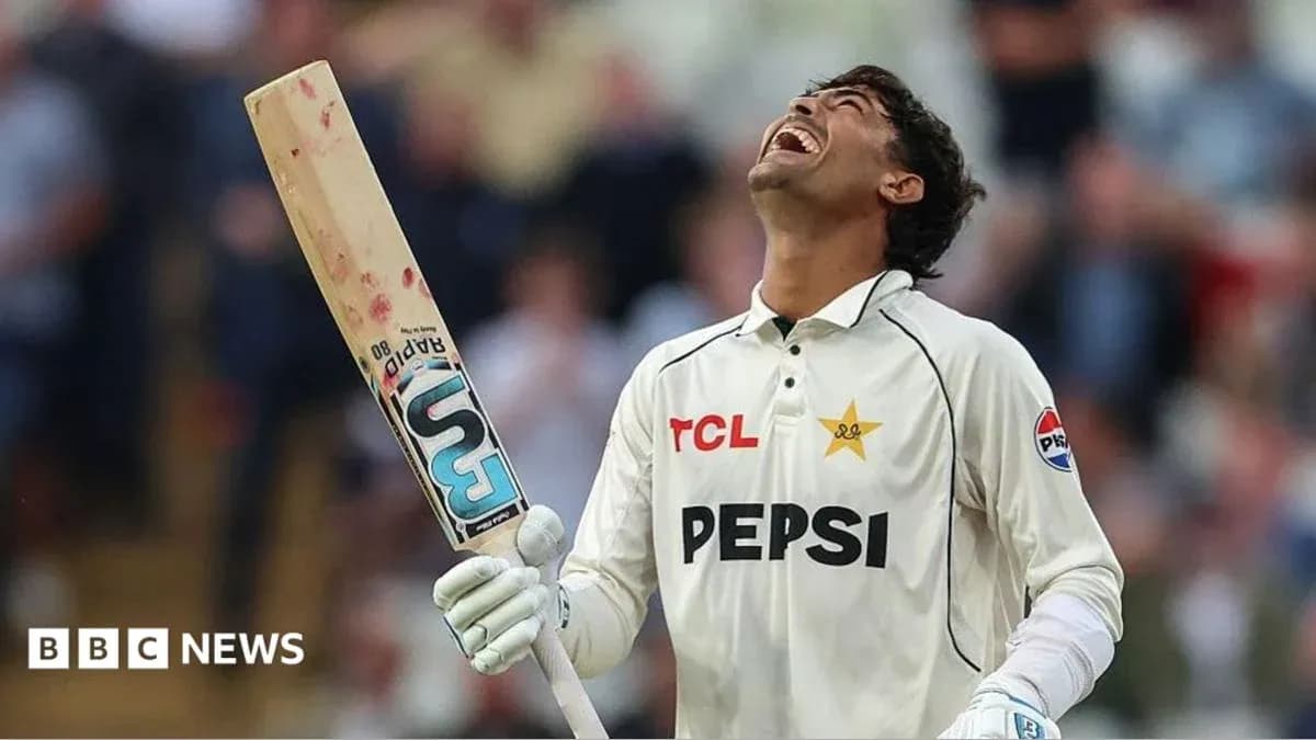 Cricketer celebrating with bat raised in victory