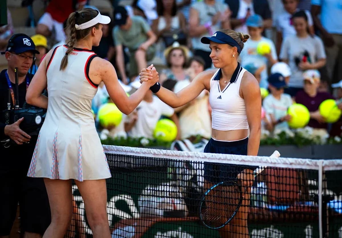 Two tennis players shaking hands at net