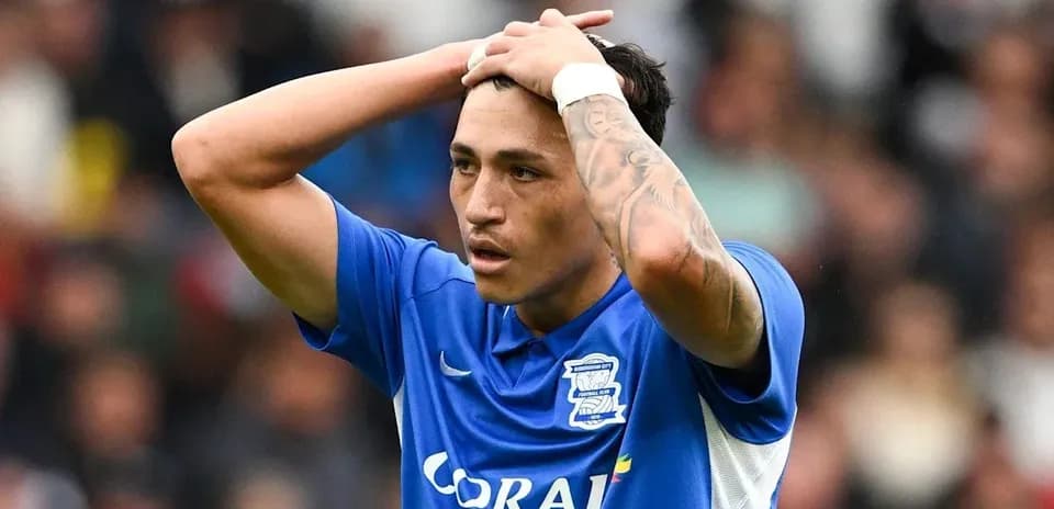 Player in blue jersey showing frustration on field