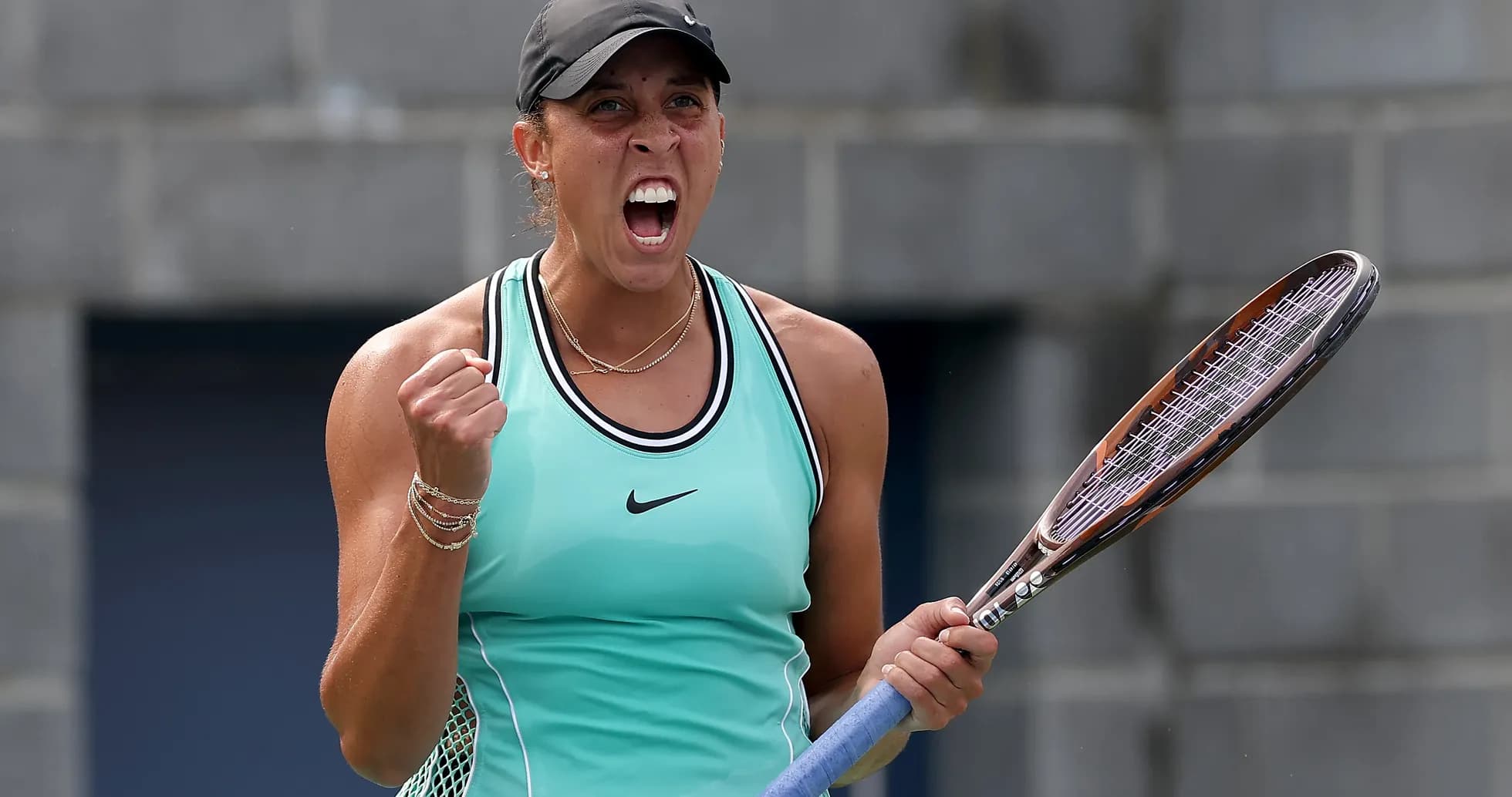 Tennis player celebrating with racket on court