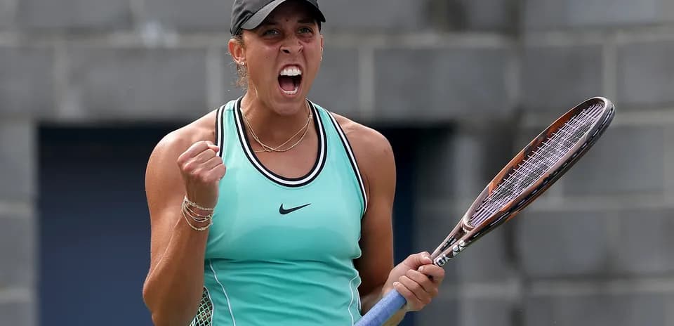 Tennis player celebrating with racket on court