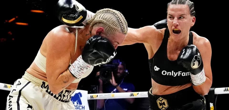 Two female boxers exchanging punches in the ring