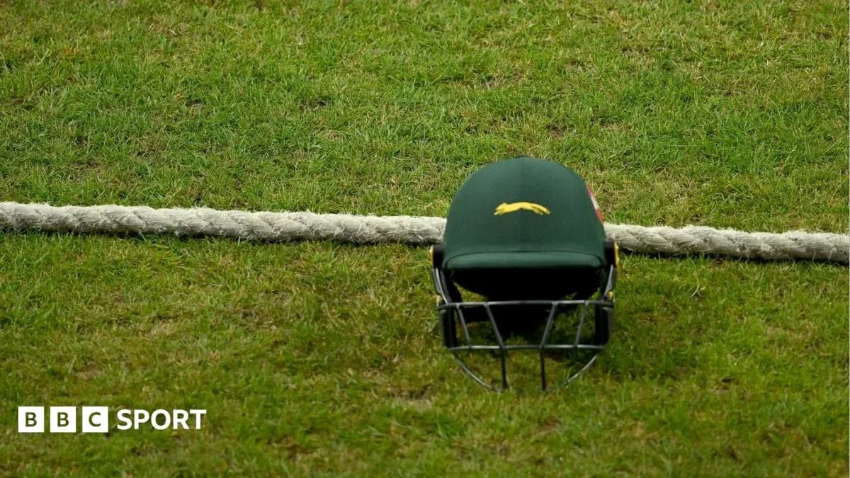 Cricket helmet resting on the grass near boundary