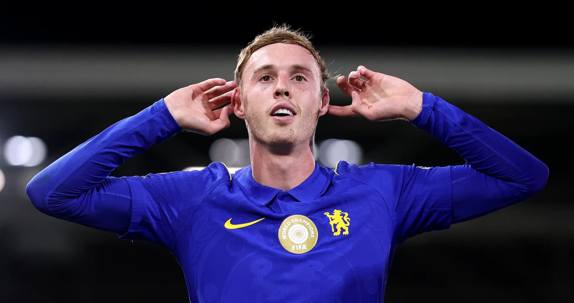 Player celebrating with hands on ears after scoring