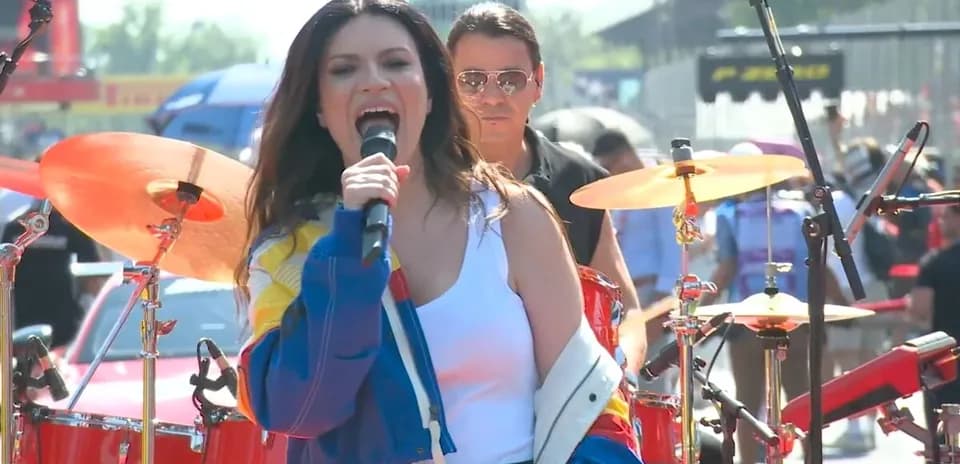 Singer performing on stage with a drummer