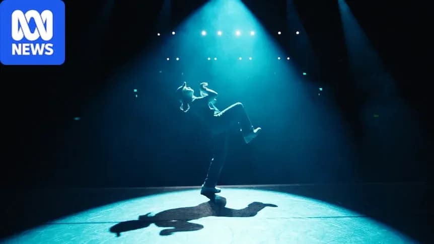 Dancer performing on stage under spotlight