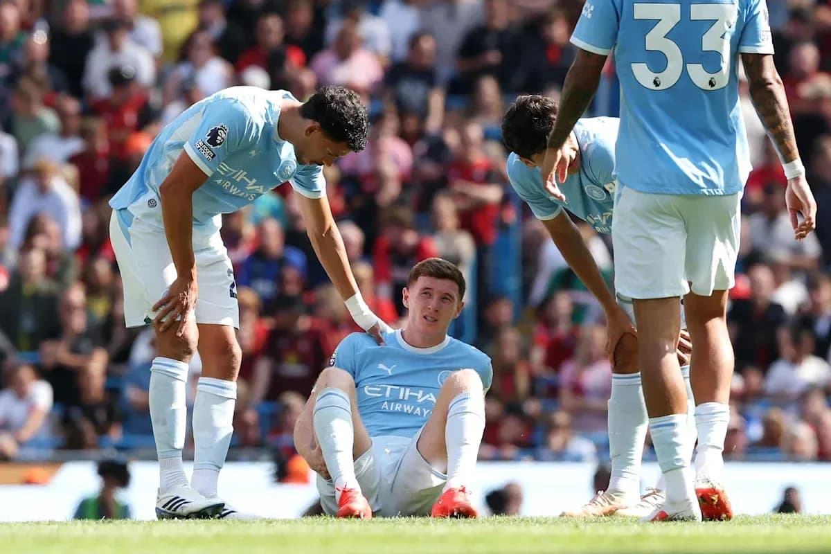 Manchester City players assisting injured teammate on field