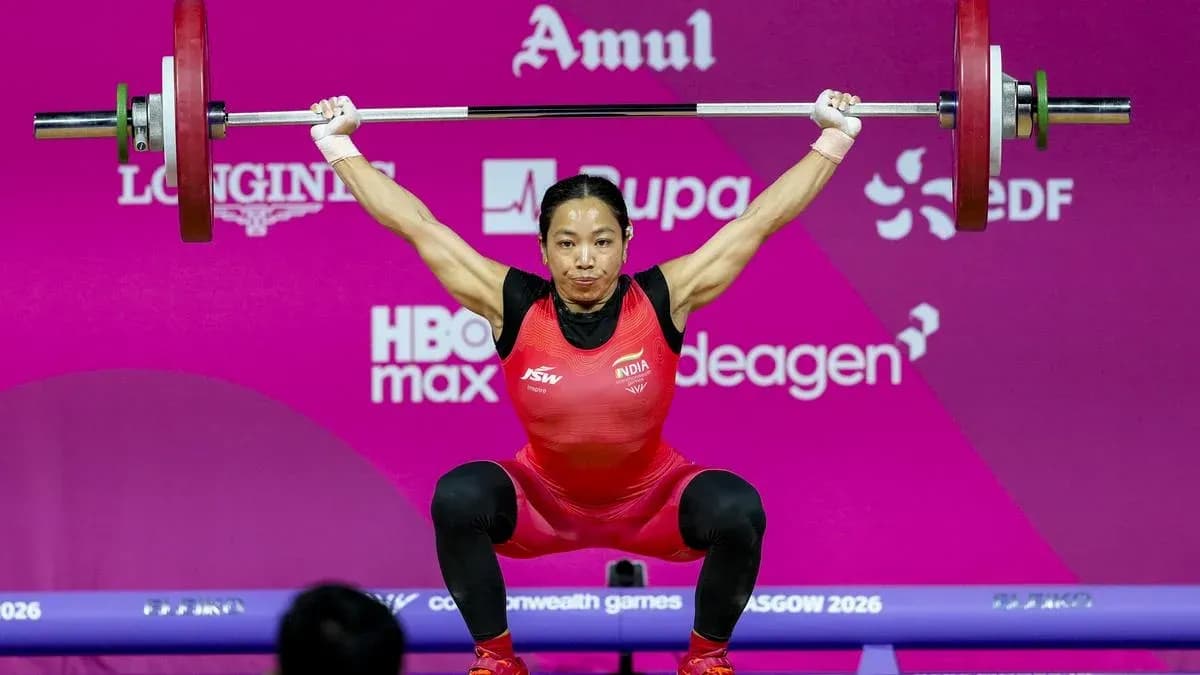 Weightlifter lifting barbell during competition