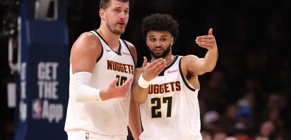 Nuggets players discussing strategy on the court