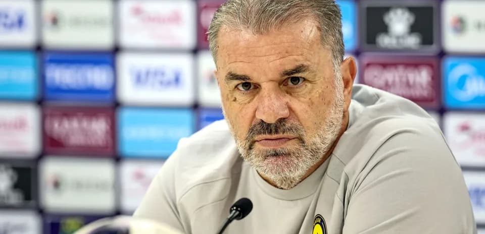 Manager speaking at press conference with microphone