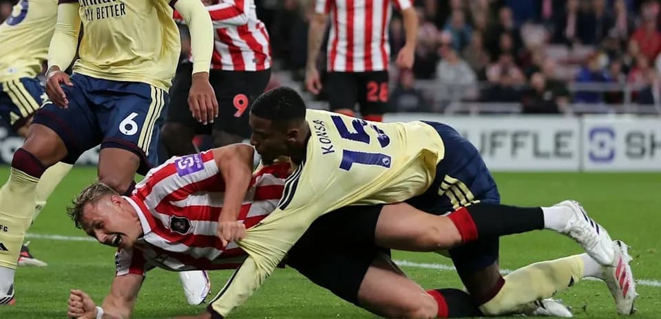 Players battling for possession on the ground