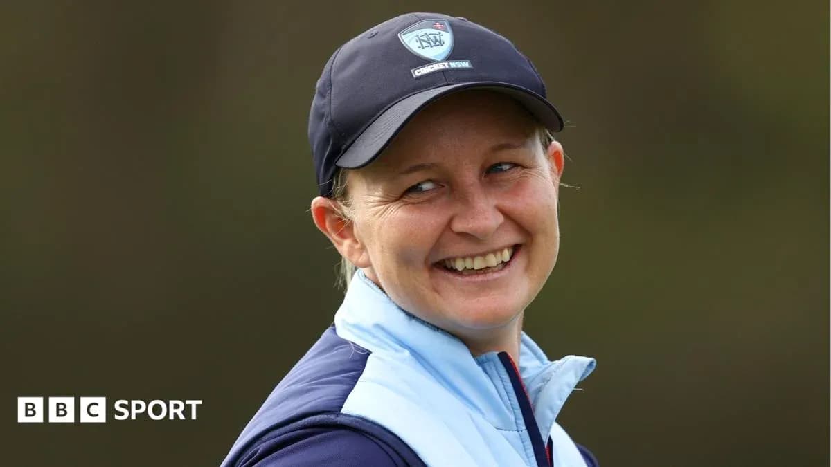 Smiling woman wearing a cap and jacket outdoors