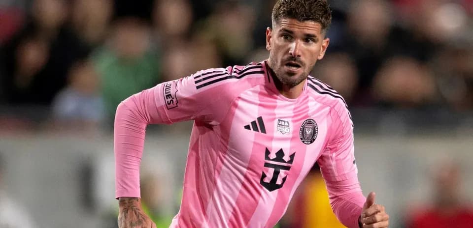 Player in pink jersey running during soccer match