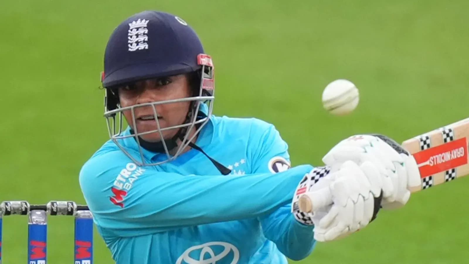 Cricketer batting with a ball approaching during match