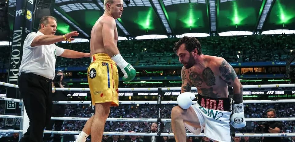 Boxer kneeling as referee checks on him