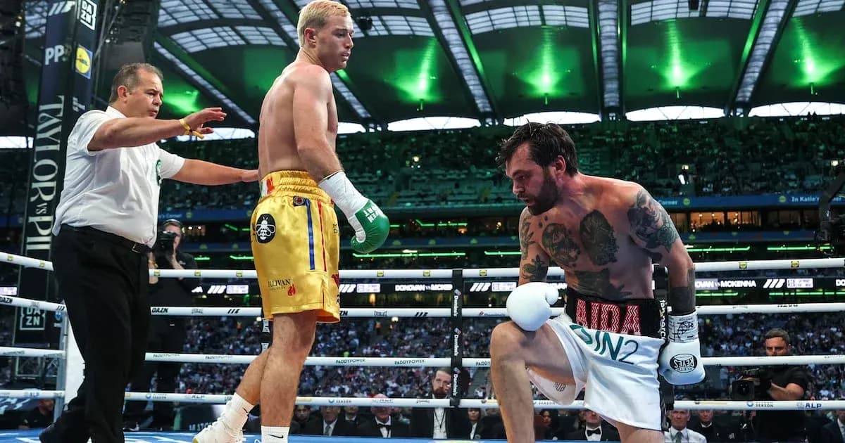 Boxer kneeling as referee checks on him