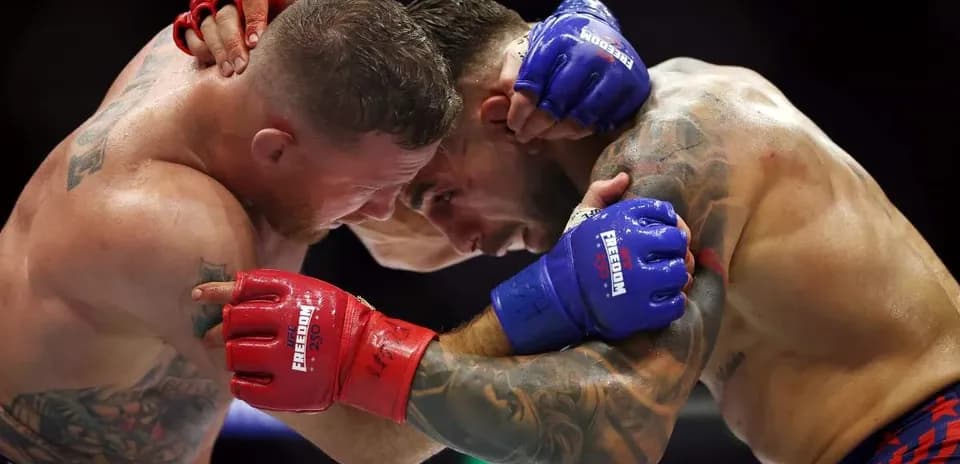 Two fighters clinching during a mixed martial arts match