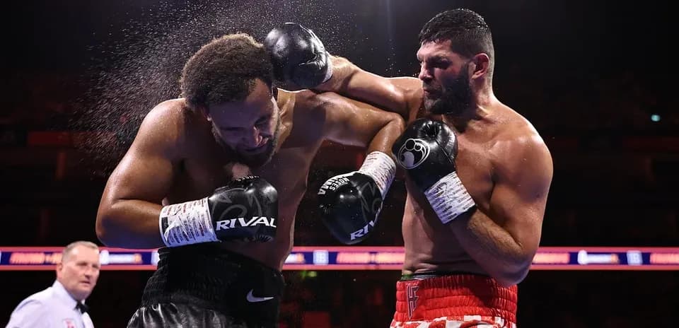 Boxers exchanging punches in a boxing ring