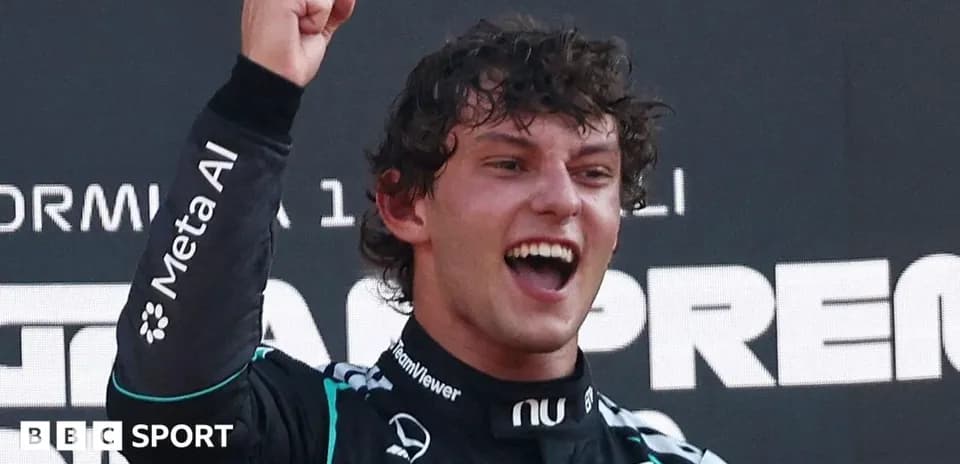 Driver celebrating victory on podium after race