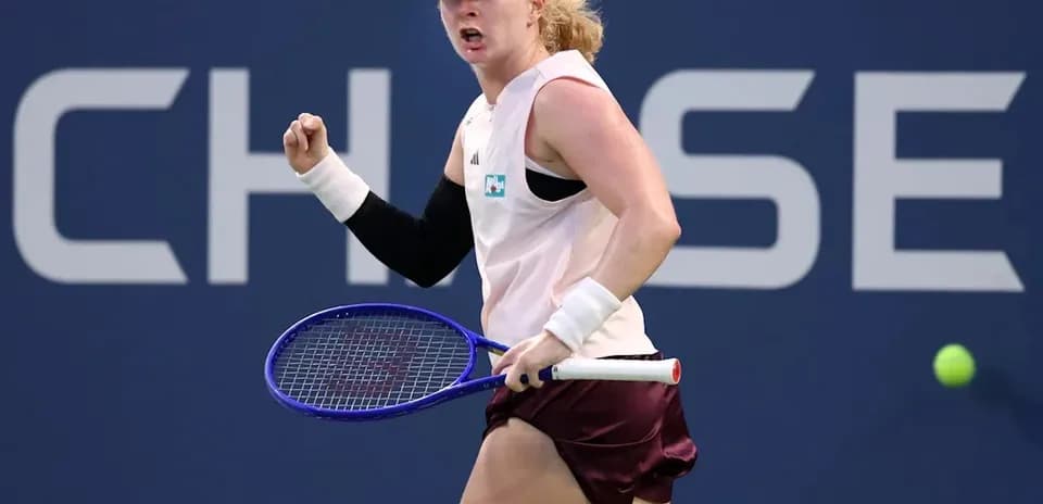Tennis player celebrating a point on court