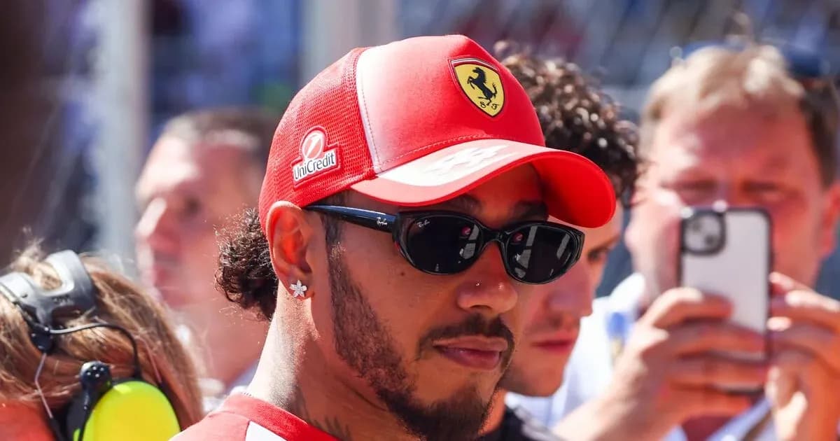 Man in Ferrari cap and sunglasses at event