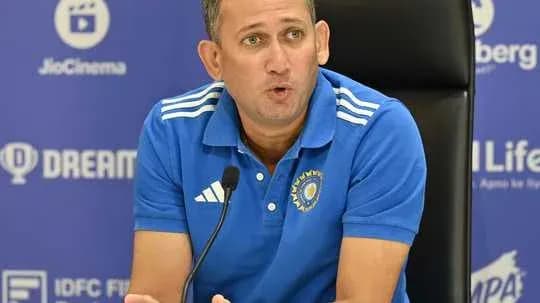 Coach speaking at press conference with microphone