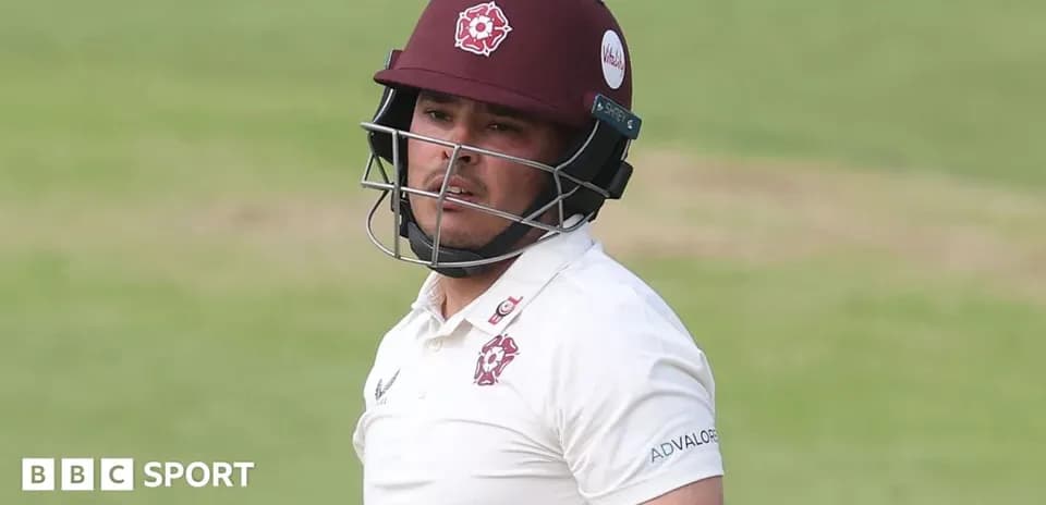 Cricketer wearing helmet during match play