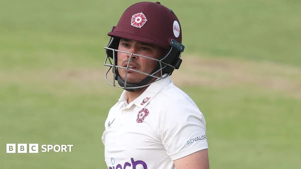 Cricketer wearing helmet during match play