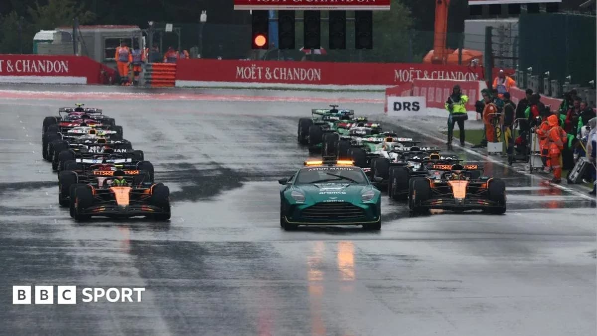 Cars lined up on track during wet race conditions