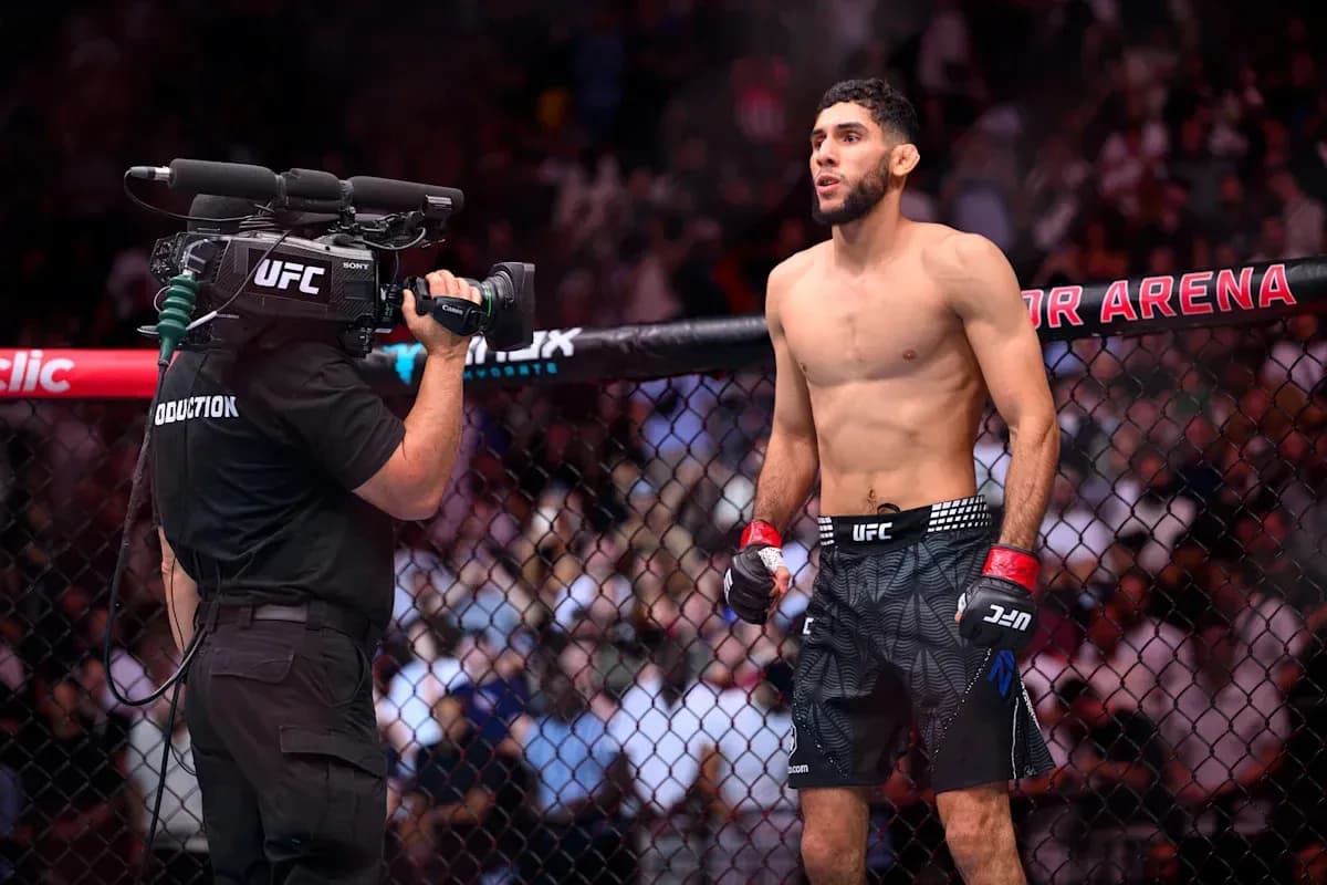 Fighter in octagon with camera crew filming
