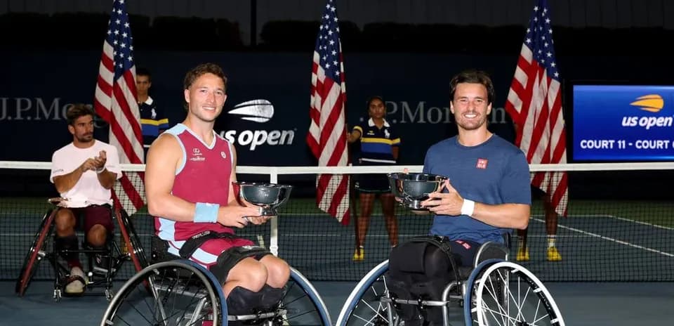 Two wheelchair tennis players holding trophies at US Open