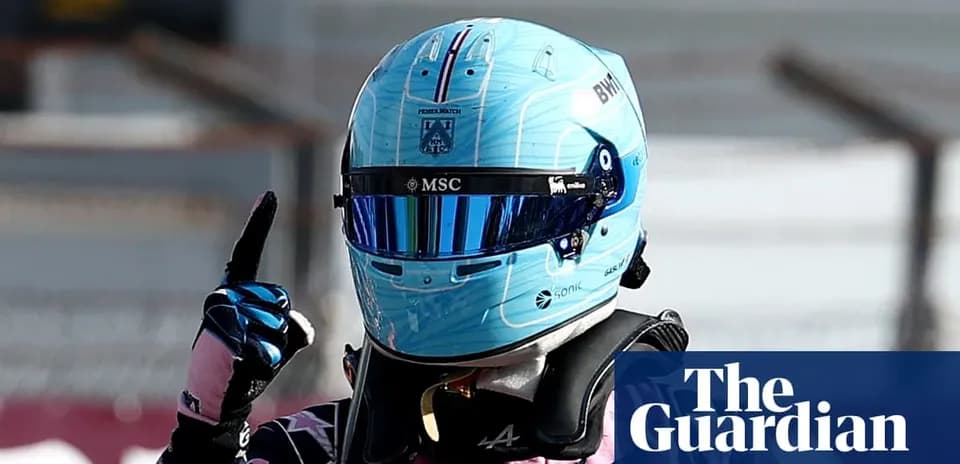 Racing driver celebrating with finger raised after race