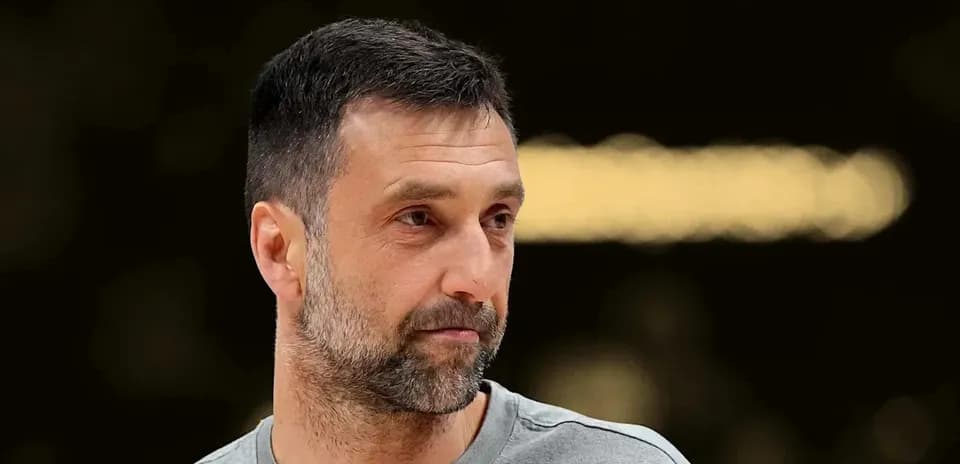 Man with short hair and beard in sports attire
