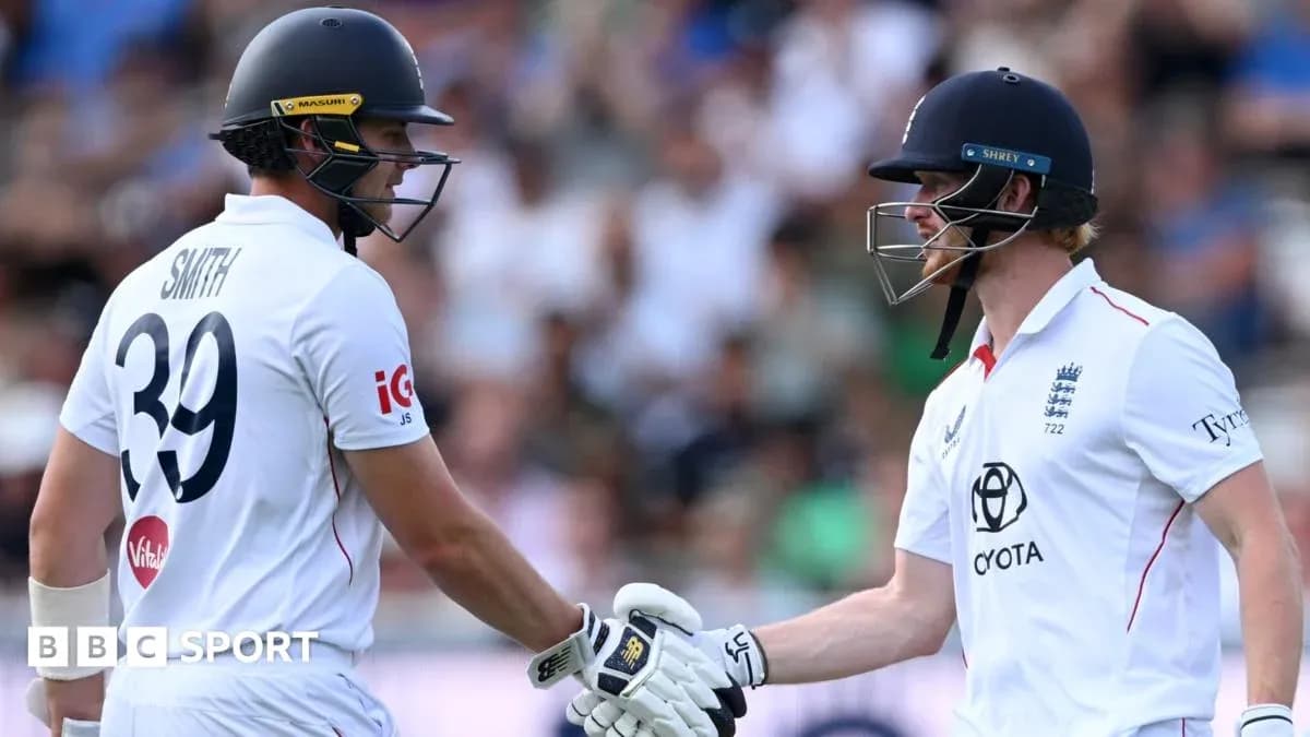 Two cricketers shaking hands on the field
