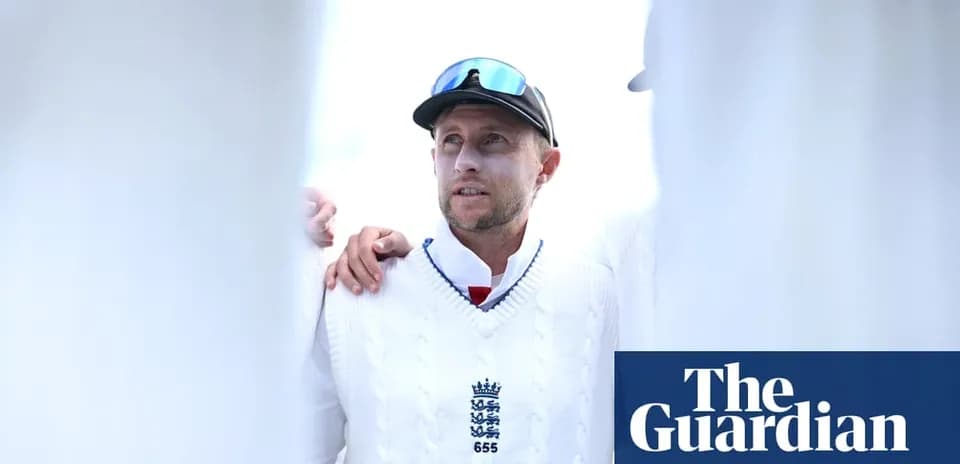 Cricketer in white sweater during team huddle