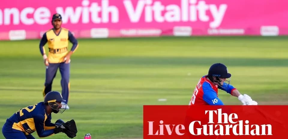 Batsman playing a shot with wicketkeeper behind