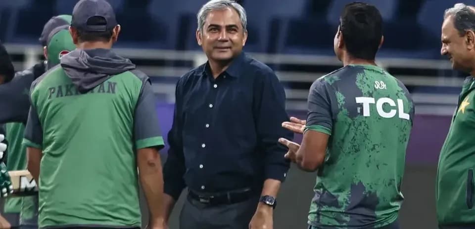 Coaching staff discussing strategies during training session