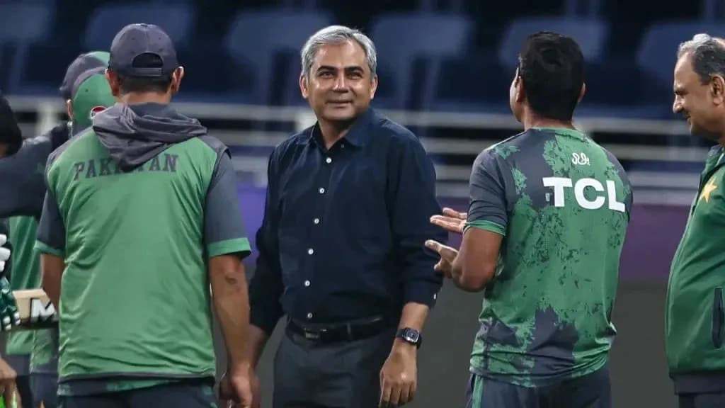 Coaching staff discussing strategies during training session