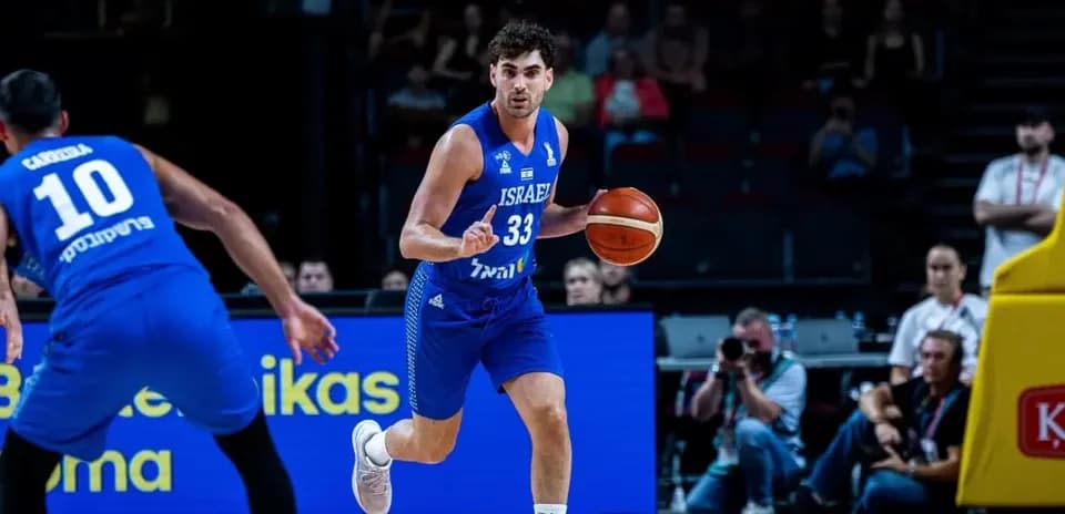 Israeli player dribbling basketball during match