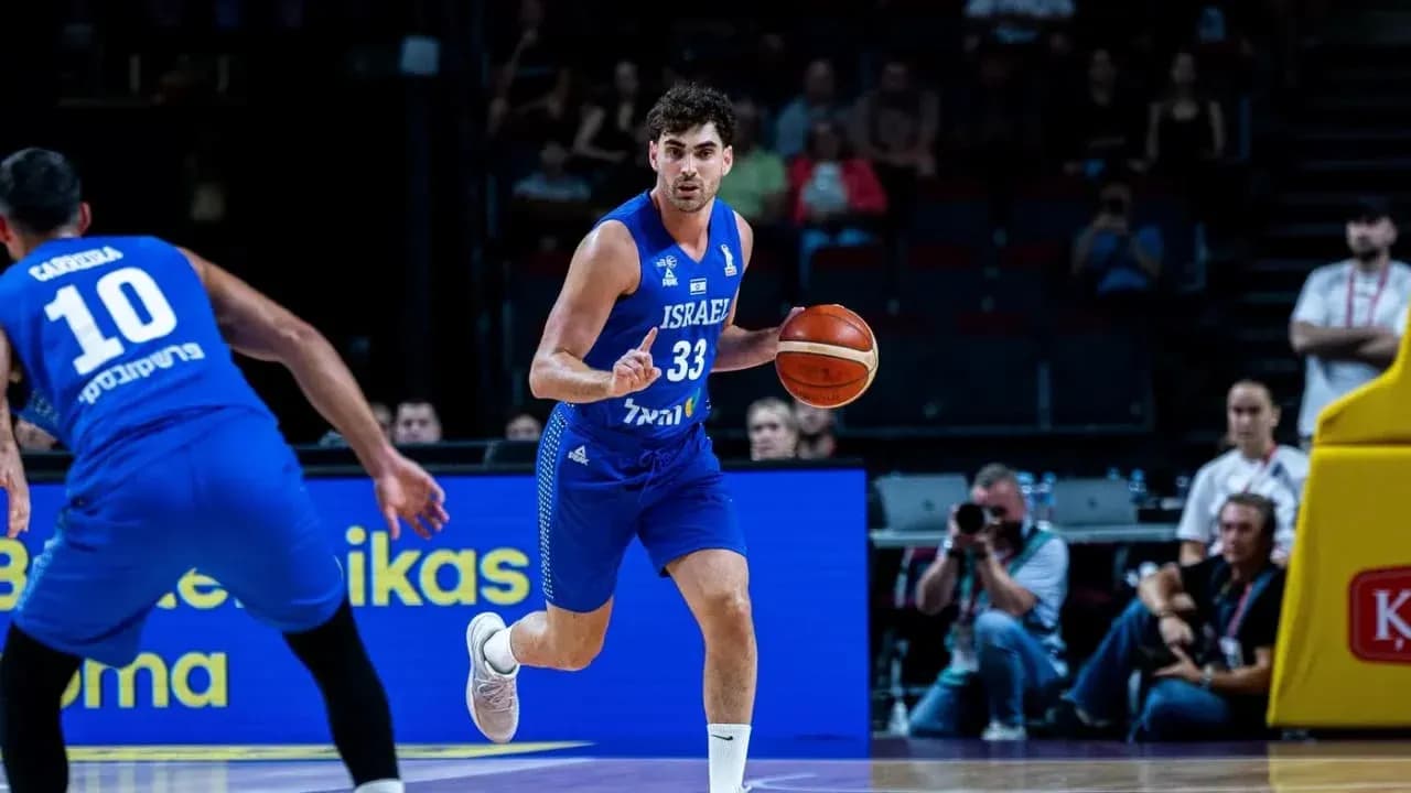 Israeli player dribbling basketball during match