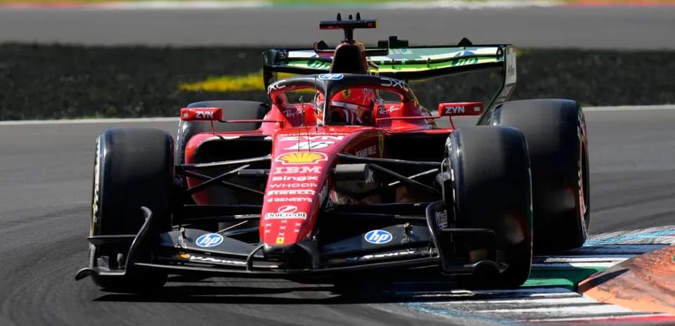 Ferrari F1 car navigating a corner on track