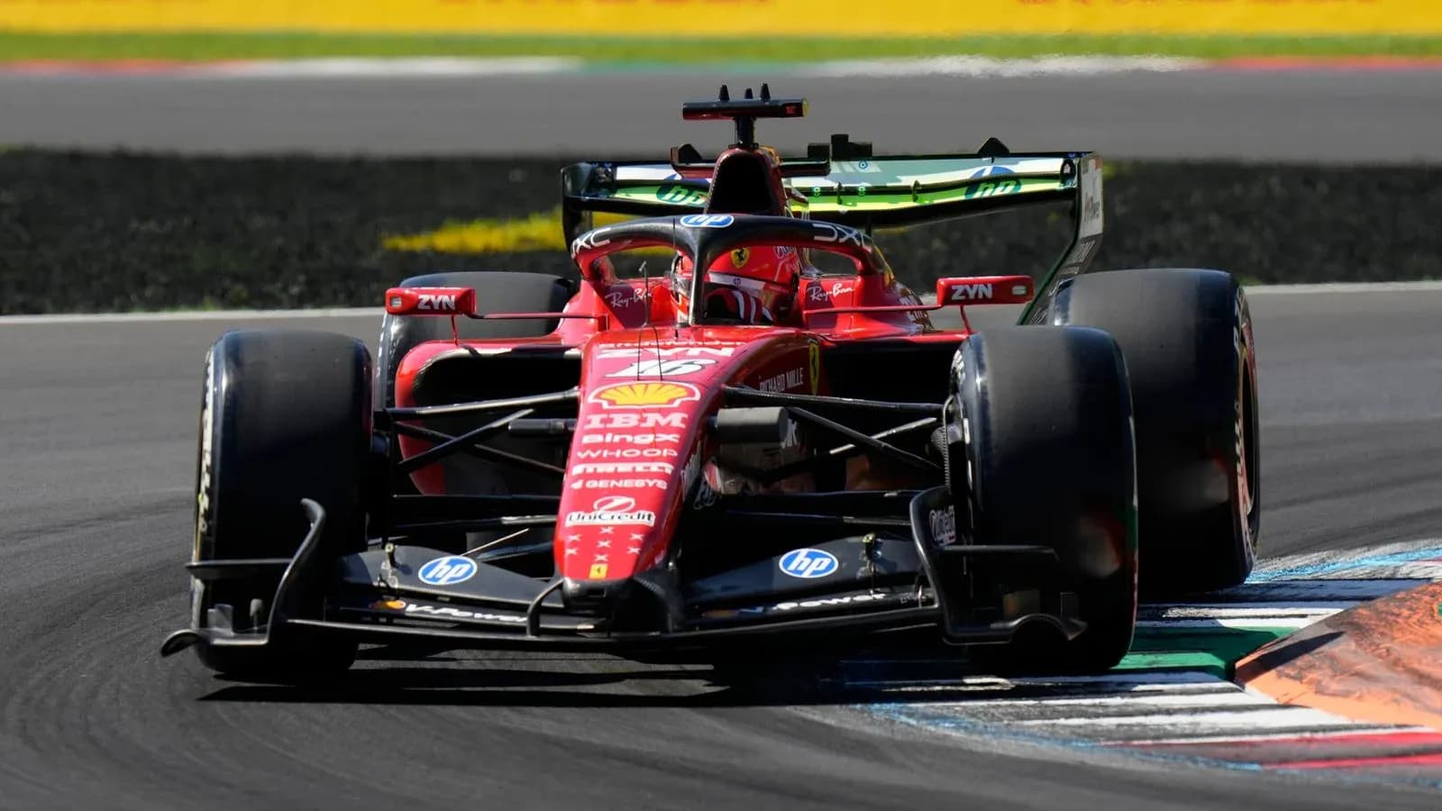 Ferrari F1 car navigating a corner on track