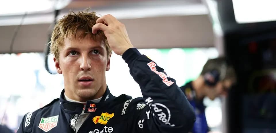Driver adjusting hair in garage before race