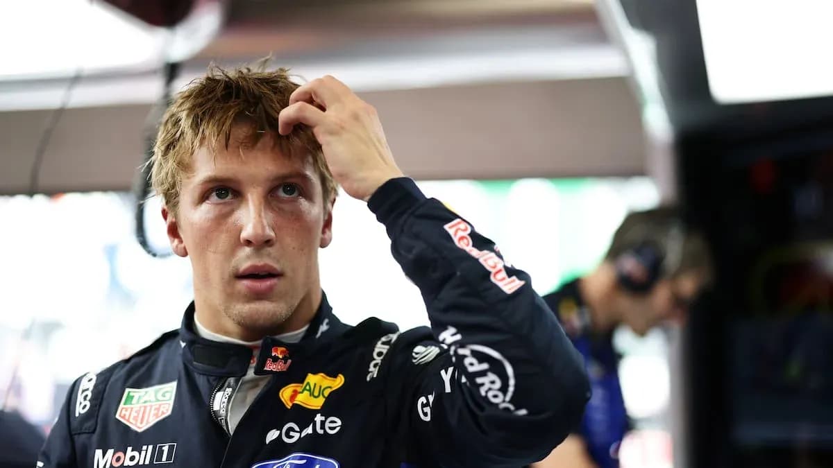Driver adjusting hair in garage before race