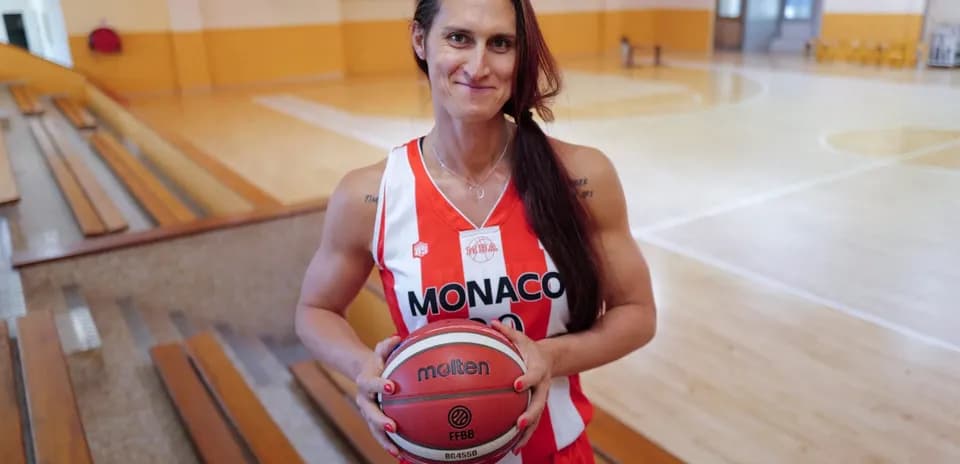 Player in Monaco jersey holding basketball in gym